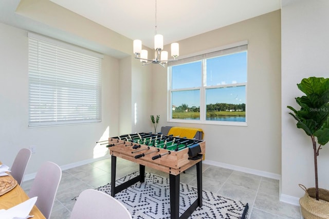 recreation room featuring light tile patterned flooring and an inviting chandelier