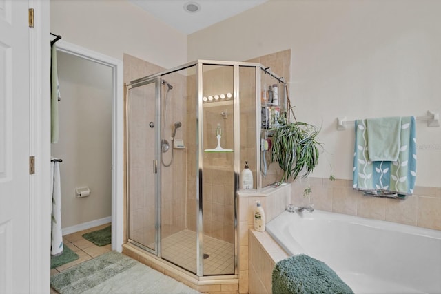 bathroom featuring independent shower and bath and tile patterned flooring