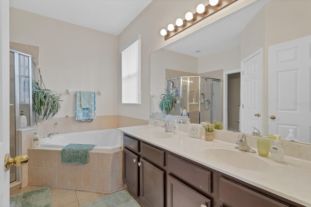 bathroom featuring shower with separate bathtub, tile patterned floors, and vanity