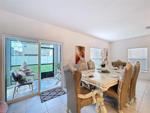 dining room featuring light tile patterned flooring and visible vents