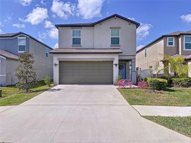 traditional-style home with a garage, driveway, a front lawn, and stucco siding