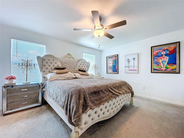 bedroom with a ceiling fan, light carpet, a textured ceiling, and baseboards