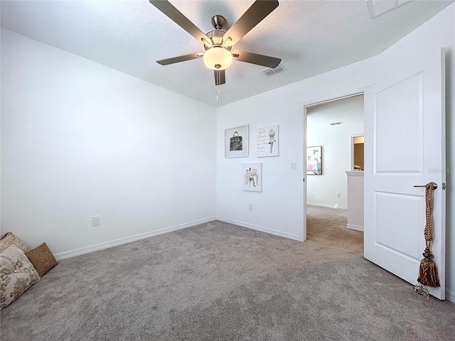 unfurnished bedroom with baseboards, light colored carpet, visible vents, and a textured ceiling