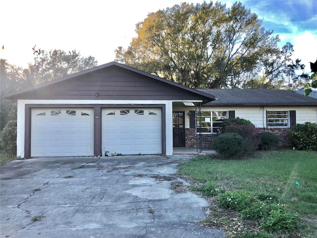 ranch-style house with a garage and a front lawn