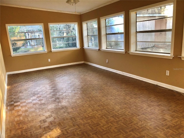 spare room with crown molding and dark parquet flooring