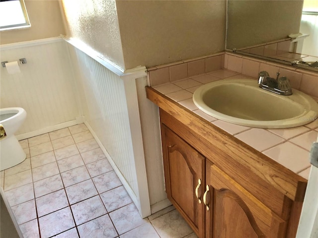 bathroom featuring tile patterned floors, vanity, and toilet