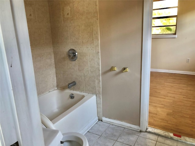 bathroom with tile patterned floors and tiled shower / bath combo