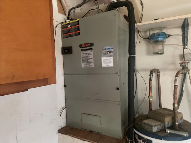 utility room featuring heating unit