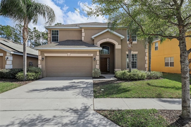 view of front of house with a front lawn and a garage