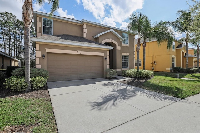 view of front of property with a front yard and a garage