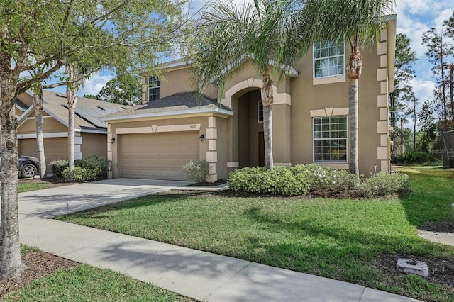 view of front of home with a front lawn and a garage