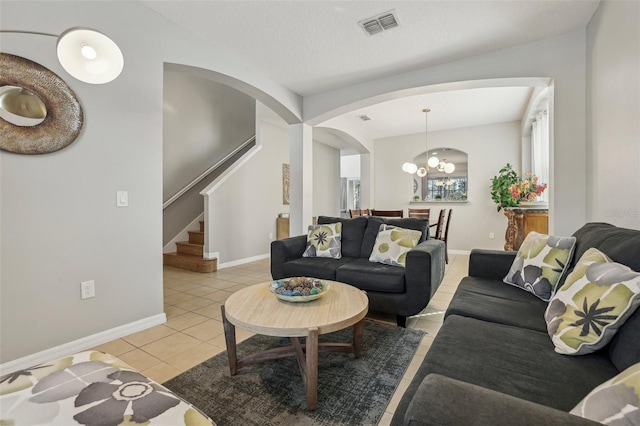 living room featuring an inviting chandelier and light tile patterned floors