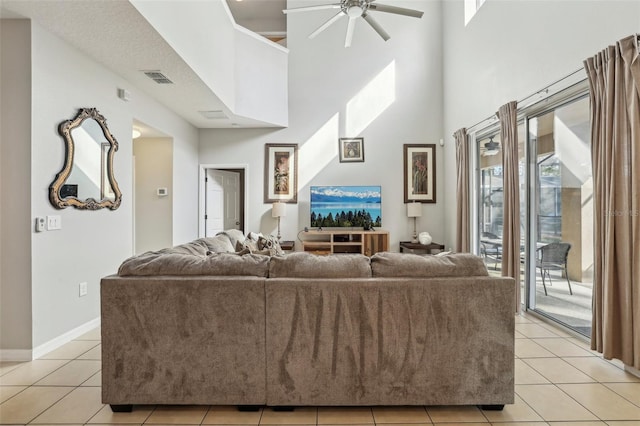 tiled living room with a high ceiling and ceiling fan