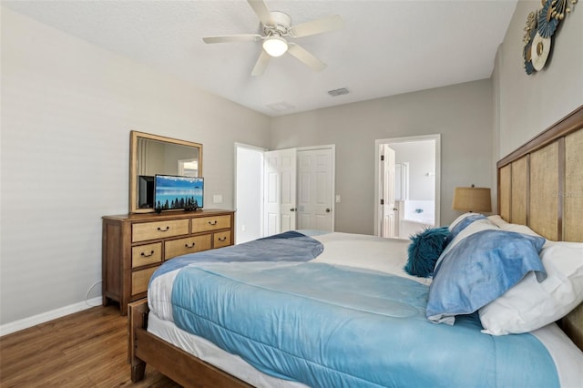 bedroom with ensuite bathroom, hardwood / wood-style floors, and ceiling fan