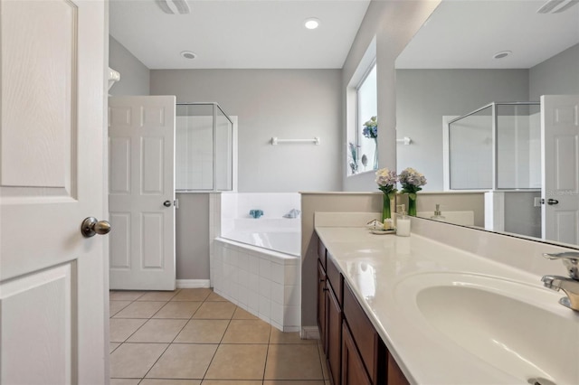 bathroom with plus walk in shower, tile patterned flooring, and vanity