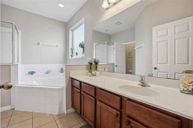 bathroom with independent shower and bath, tile patterned flooring, and vanity