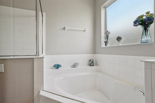 bathroom featuring tiled tub