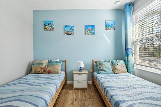 bedroom with a textured ceiling and hardwood / wood-style floors