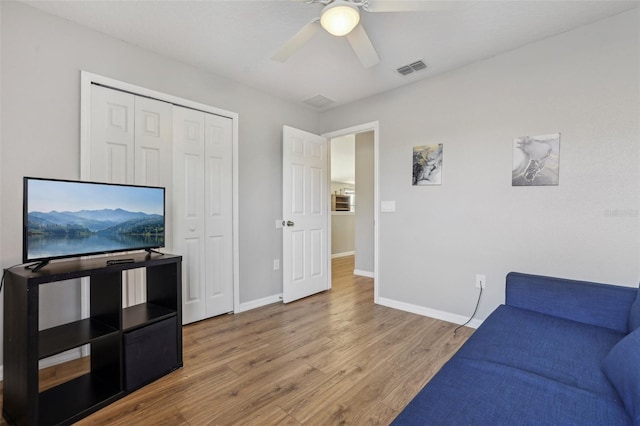 living room featuring ceiling fan and wood-type flooring