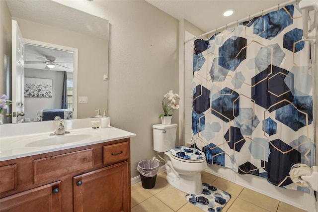 bathroom with vanity, toilet, tile patterned floors, and walk in shower