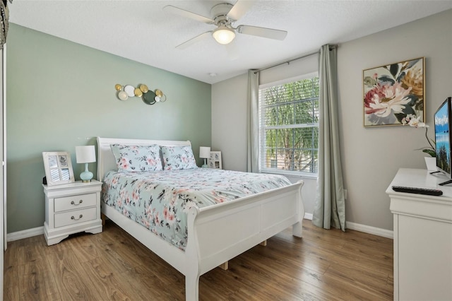 bedroom with ceiling fan and dark wood-type flooring