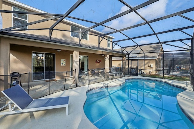 view of swimming pool featuring a lanai, ceiling fan, and a patio area