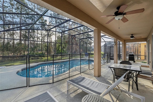 view of swimming pool featuring a patio, ceiling fan, and a lanai