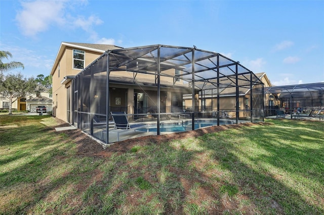 rear view of property featuring a patio, a lanai, and a lawn