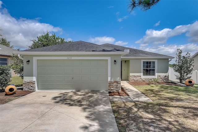 ranch-style house featuring a garage and a front lawn