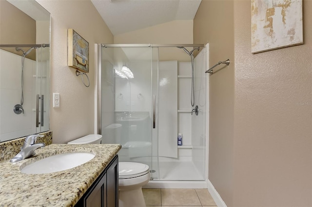 bathroom featuring a shower with door, vanity, vaulted ceiling, tile patterned floors, and toilet