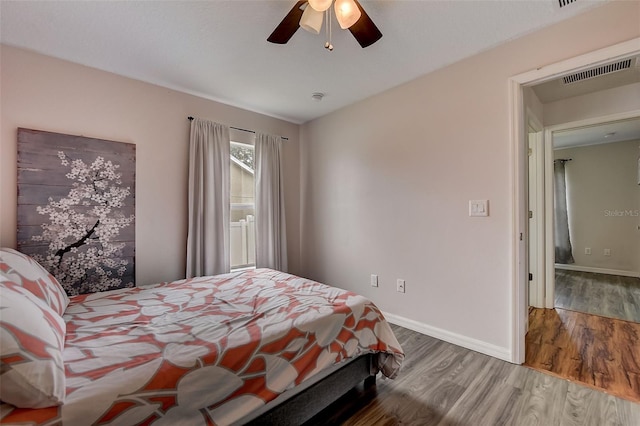 bedroom with ceiling fan and wood-type flooring