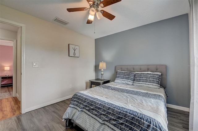 bedroom with hardwood / wood-style floors and ceiling fan