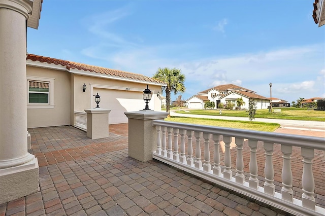 view of patio / terrace with a residential view and an attached garage