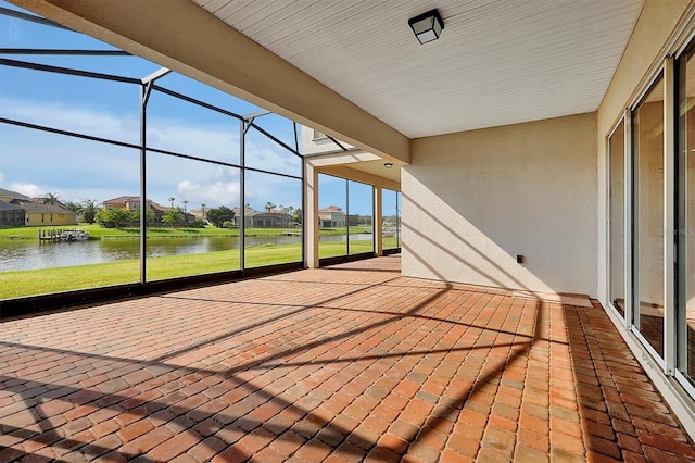 unfurnished sunroom with a water view