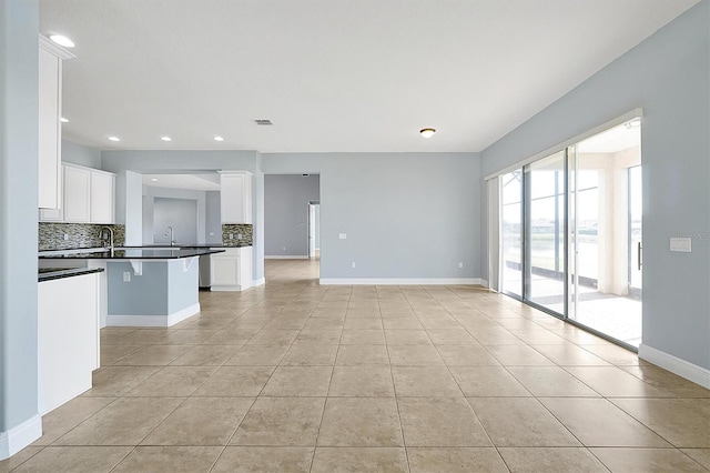 unfurnished living room with recessed lighting, visible vents, baseboards, and light tile patterned floors