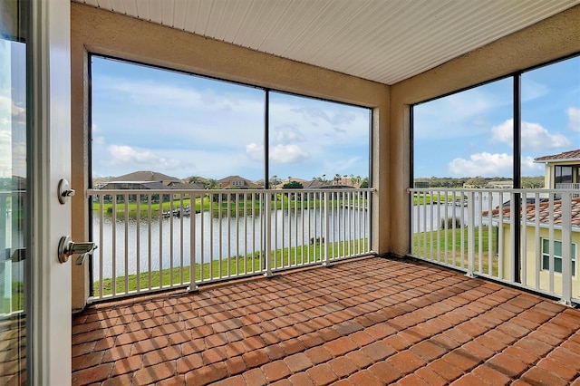 unfurnished sunroom with a water view