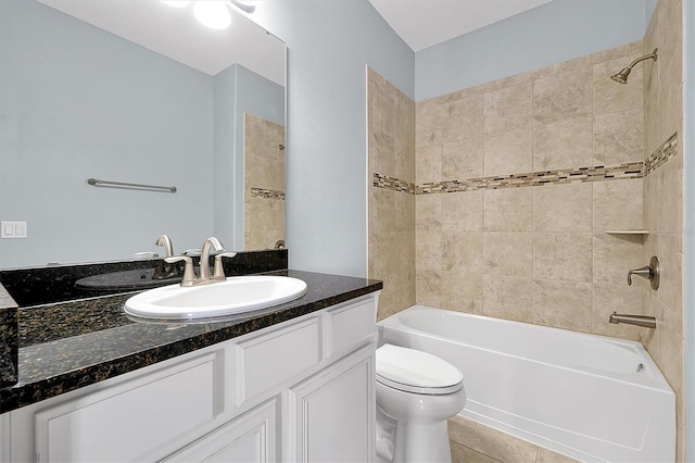 full bath with  shower combination, vanity, toilet, and tile patterned floors