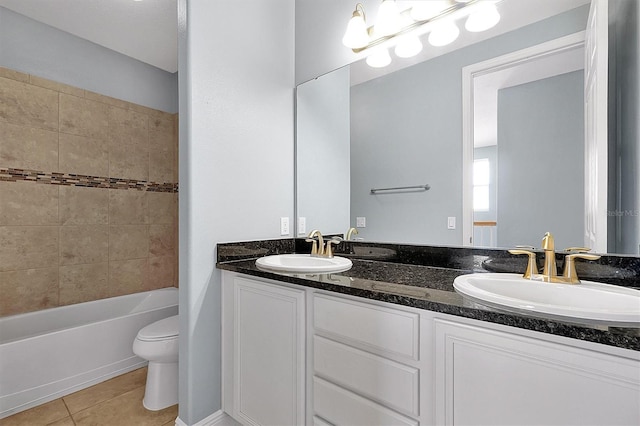 full bath with double vanity, a sink, toilet, and tile patterned floors