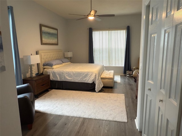 bedroom with dark hardwood / wood-style floors and ceiling fan