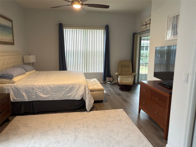 bedroom with dark hardwood / wood-style flooring and ceiling fan