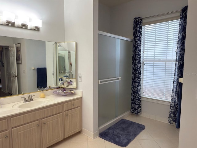 bathroom with an enclosed shower, vanity, and tile patterned flooring