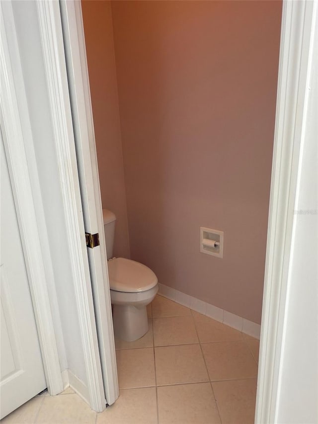 bathroom featuring toilet and tile patterned flooring