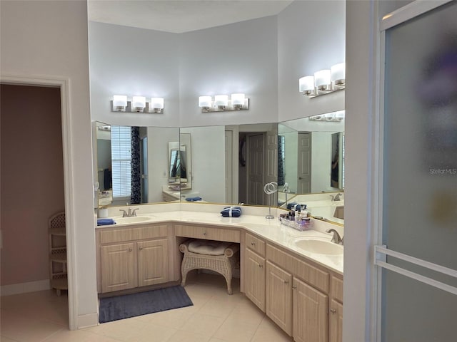 bathroom featuring vanity, a towering ceiling, and tile patterned floors