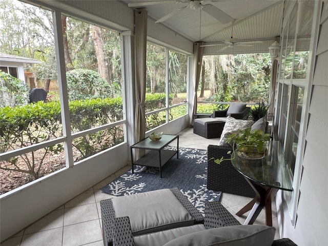 sunroom with ceiling fan and vaulted ceiling