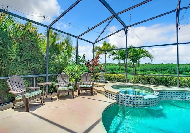 view of swimming pool featuring a lanai, a patio, and an in ground hot tub