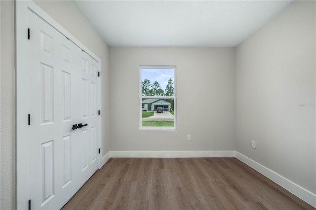 unfurnished room featuring light wood-style floors and baseboards