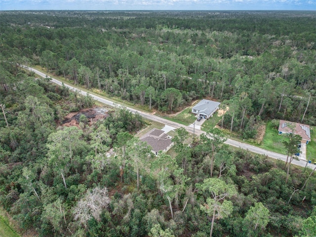 drone / aerial view featuring a forest view