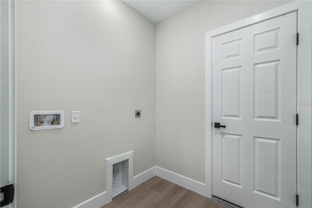 laundry area featuring hookup for a washing machine, hookup for an electric dryer, wood finished floors, laundry area, and baseboards