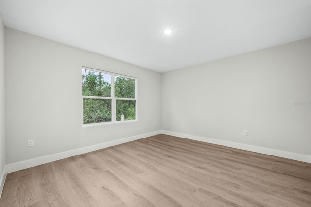 spare room with light wood finished floors and baseboards