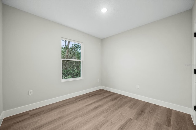 empty room with light wood-style floors and baseboards